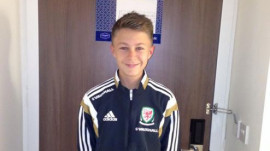 Dom in his Wales football tracksuit